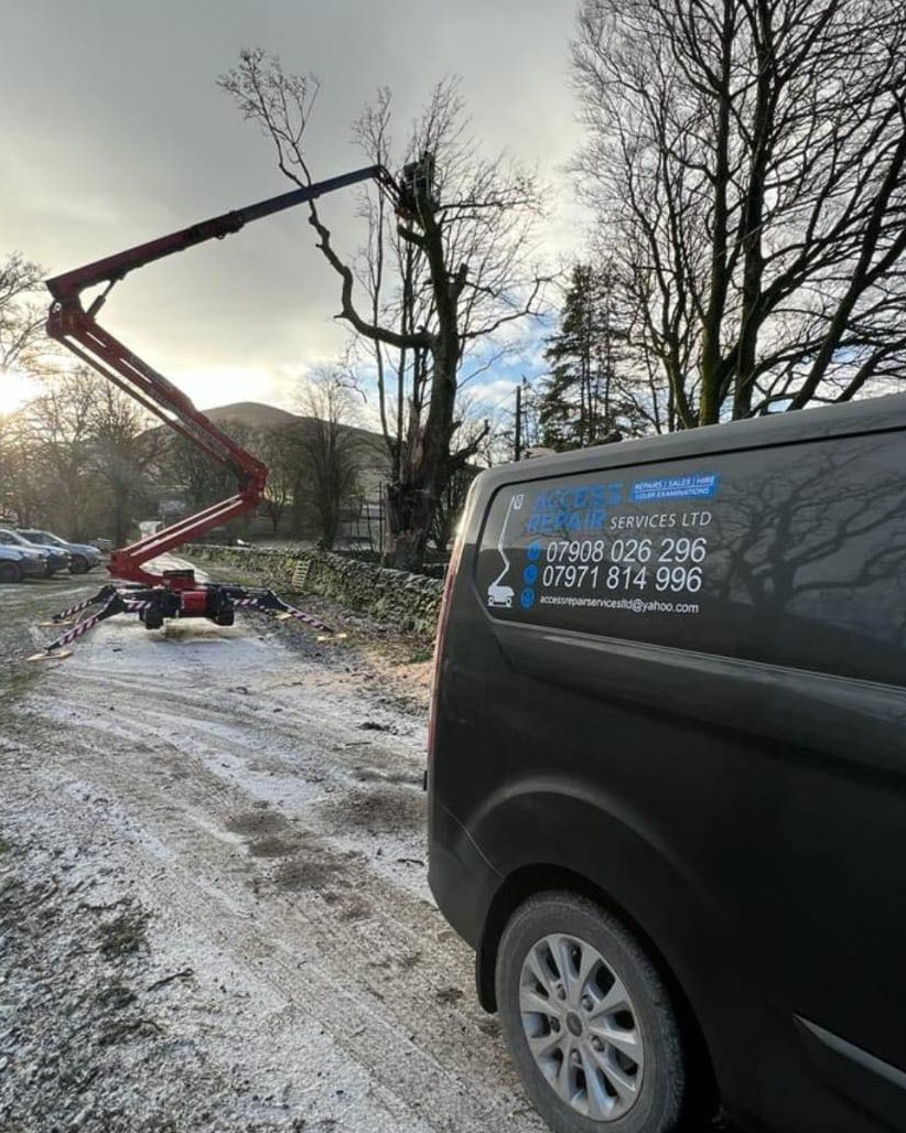 Access Repair's Custom wraped van beside their equipment